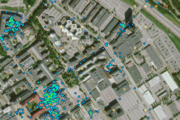 An aerial heatmap photo of buildings and parking lots